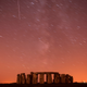 A meteor streaks past stars in the night sky over Stonehenge in Salisbury Plain, southern England.